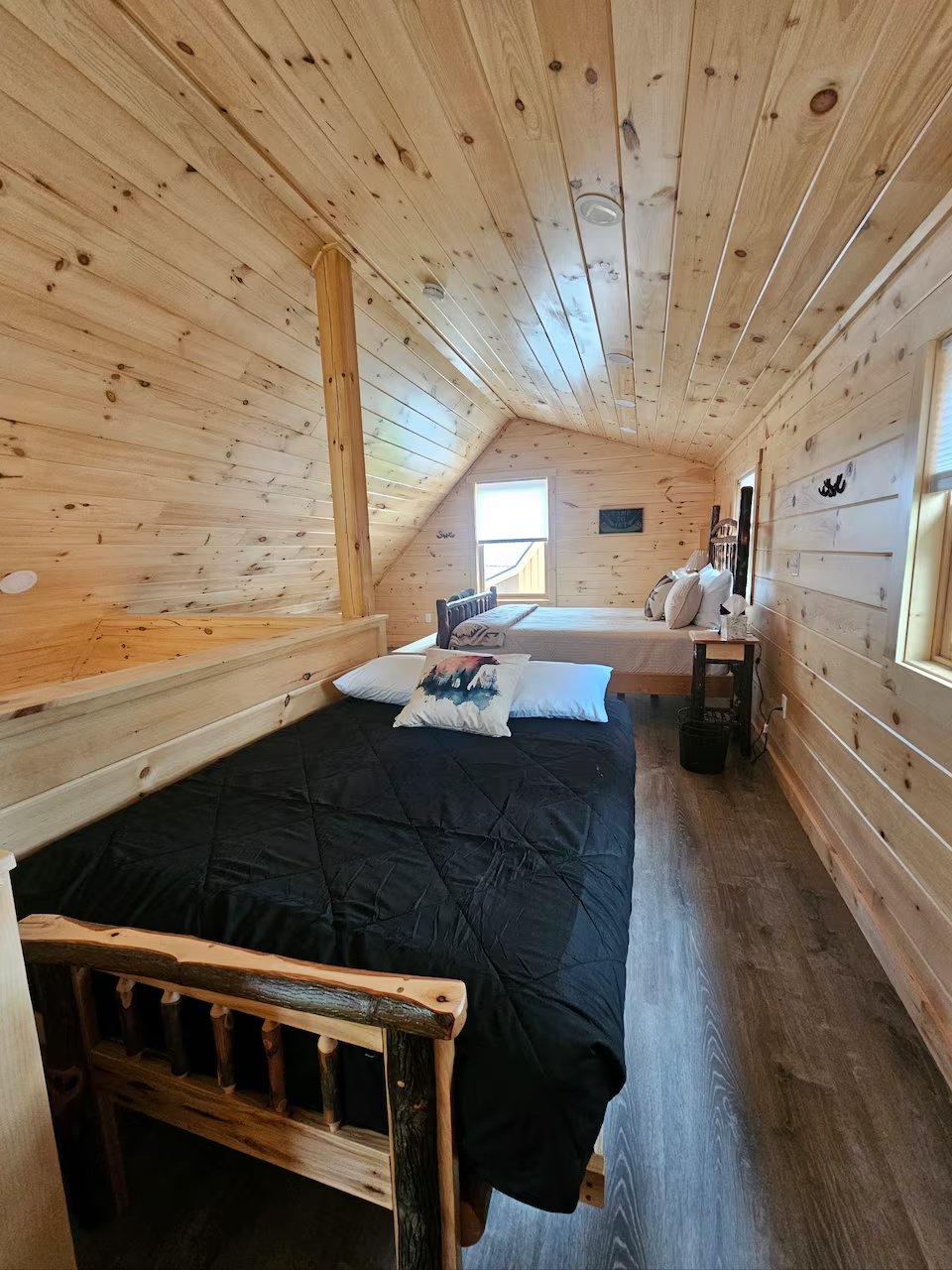 Upstairs loft bedroom with A-frame ceiling in Swiftwater cabin