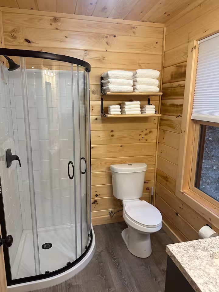 Clean bathroom with walk-in shower in Swiftwater cabin